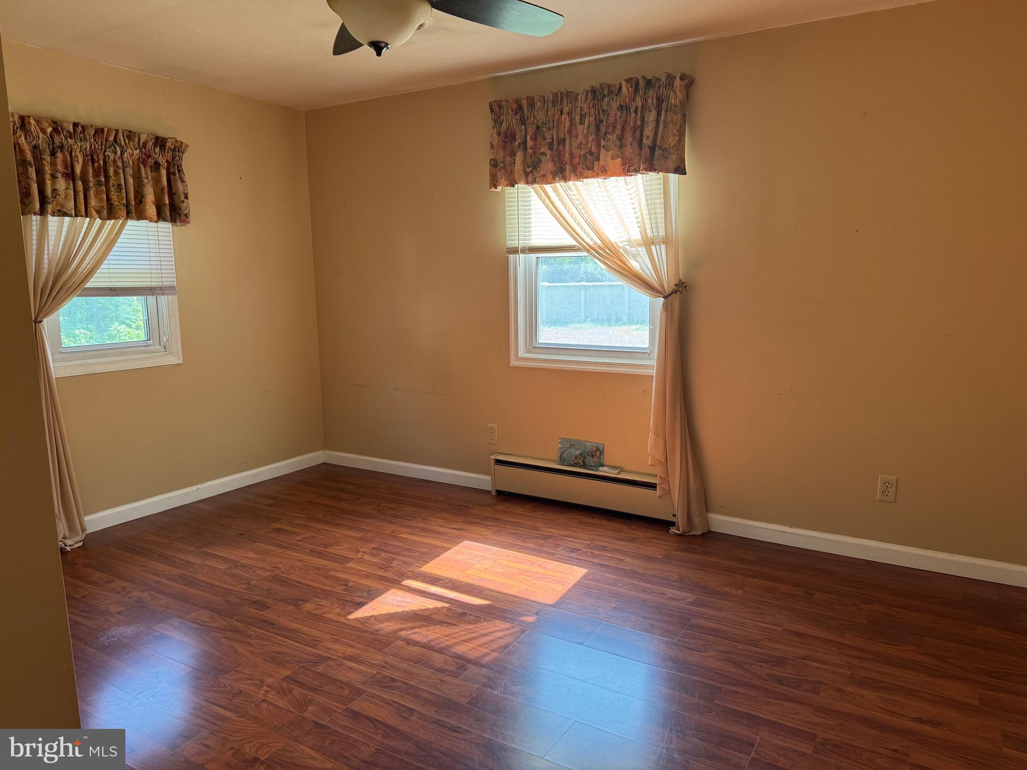 304 Cool Hollow Road Falling Waters, WV 25419 - Photo 31 of 42 an empty room with wooden floor and windows