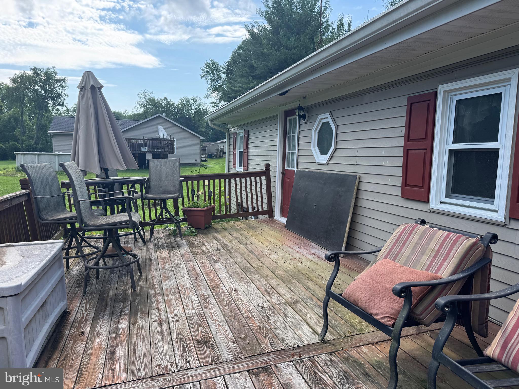 304 Cool Hollow Road Falling Waters, WV 25419 - Photo 5 of 42 a view of a patio with table and chairs with wooden floor and fence