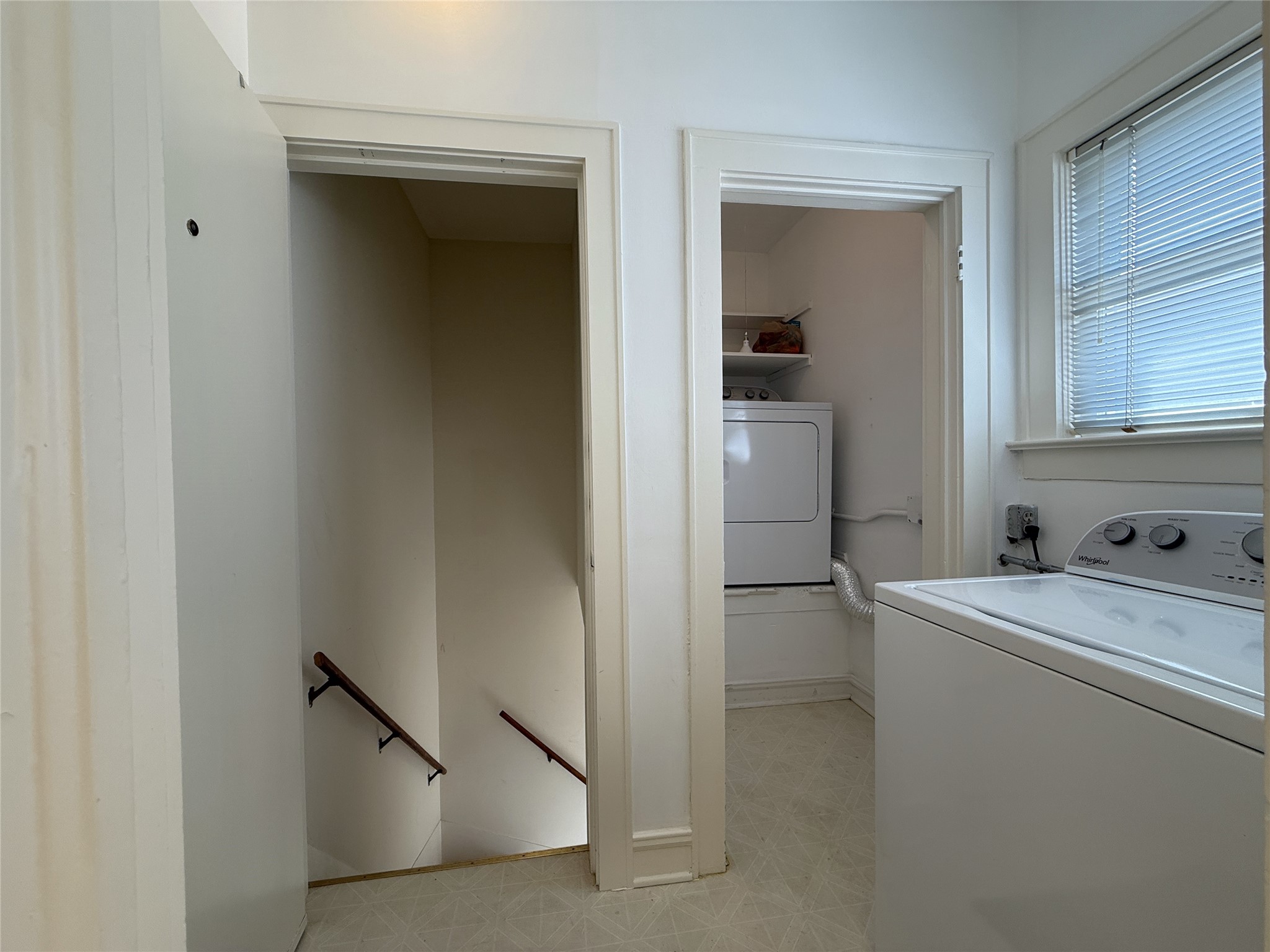 2311 Wroxton Road Houston, TX 77005 - Photo 13 of 24 From a window, natural light flows into the laundry room. Stairs lead down to the driveway & off street parking.