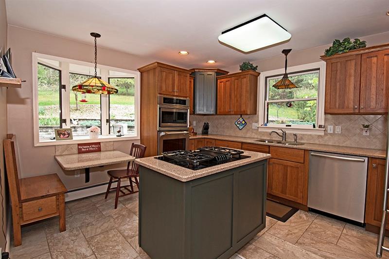 56 Creek Road Sandy Lake, PA 16145 - Photo 9 of 24 Quartz Counter,ceramic tile floor,hickory cabinets,gas cook top with vent.