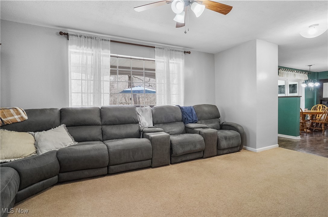 35977 Teegarden Road Salem, OH 44460 - Photo 13 of 50 Living area featuring ceiling fan with notable chandelier, baseboards, and carpet flooring