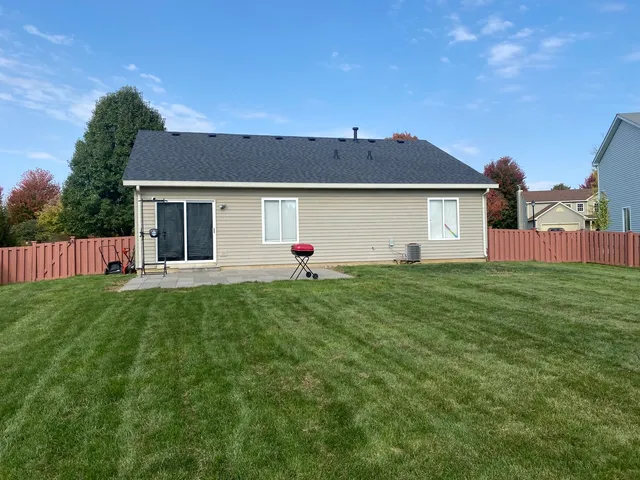 a front view of house with yard and green space