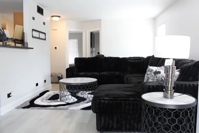 a living room with furniture and a lamp