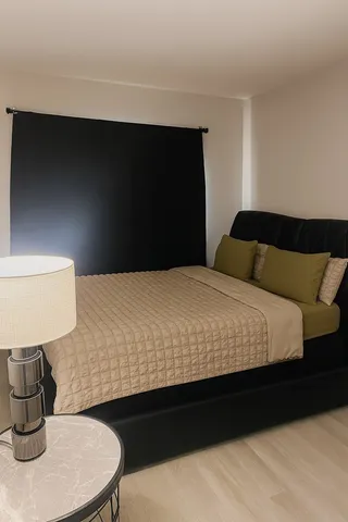 a bedroom with a bed lamp and a fireplace