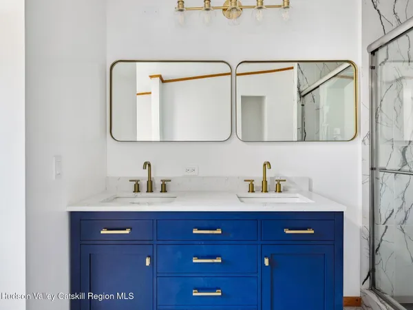 a bathroom with a sink vanity and mirror