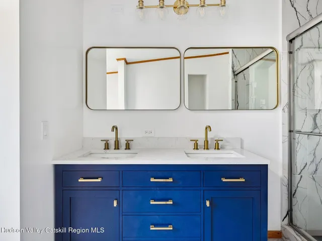 a bathroom with a sink vanity and mirror