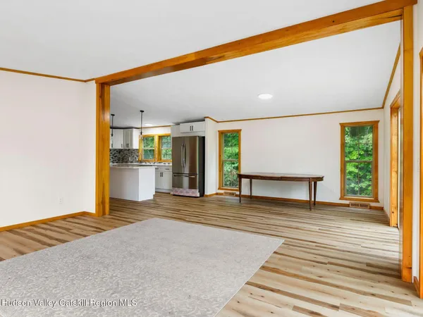 a view of a room with wooden floor and a window