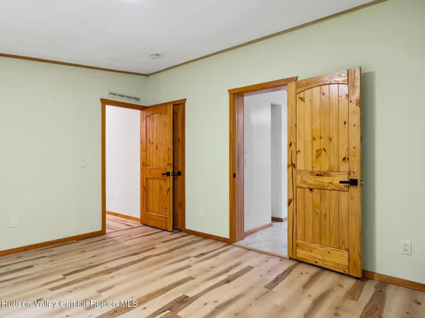 a view of front door with wooden floor