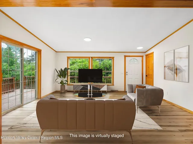 a living room with furniture window and a flat screen tv