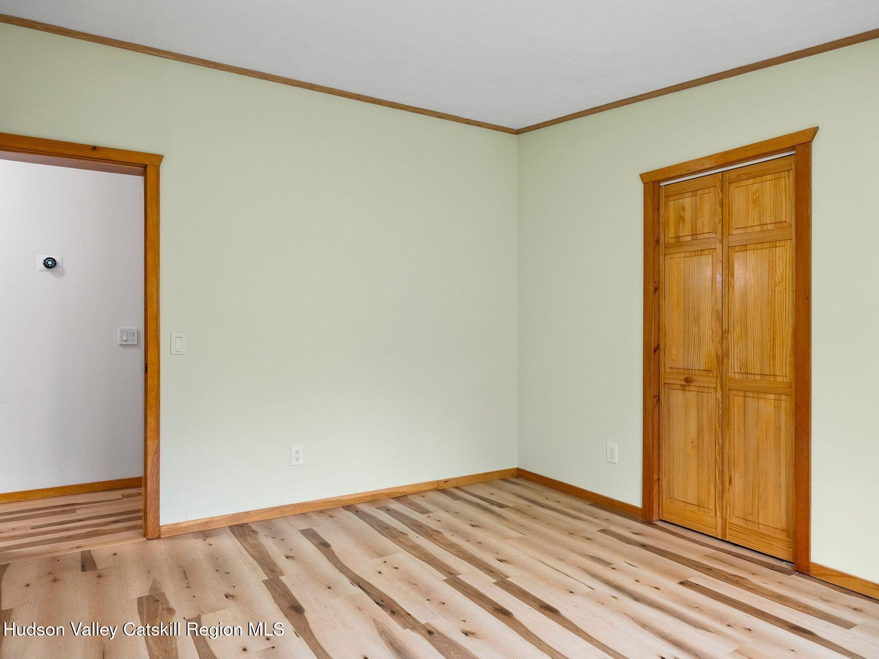719 Allen Teator Road Durham, NY 12469 - Photo 22 of 38 an empty room with wooden floor and closet area
