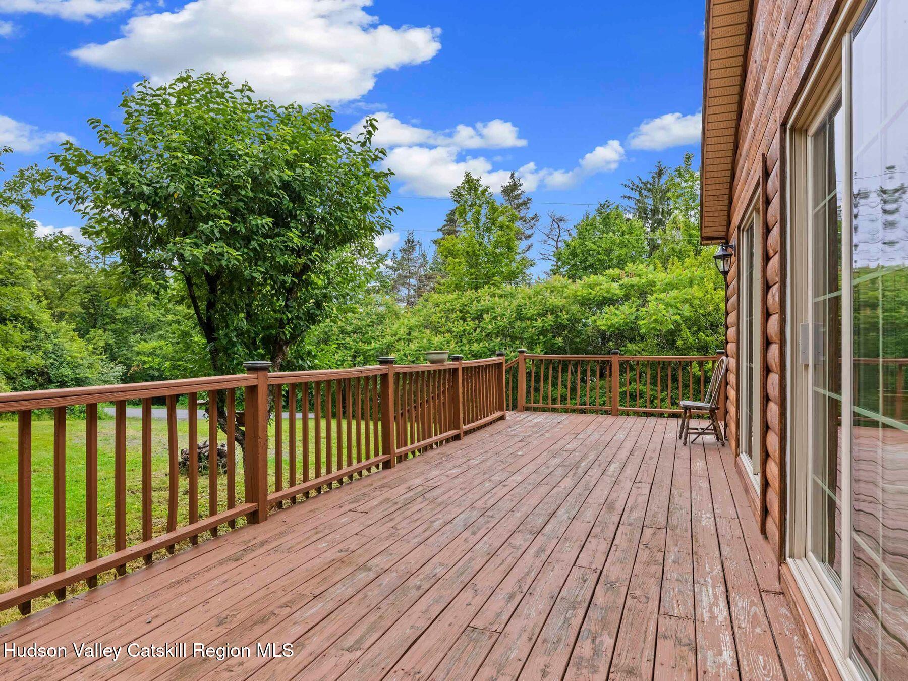 719 Allen Teator Road Durham, NY 12469 - Photo 31 of 38 a balcony with wooden floor and fence