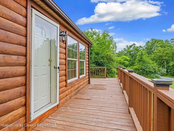 a view of balcony with wooden floor and fence