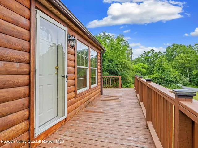 a view of balcony with wooden floor and fence