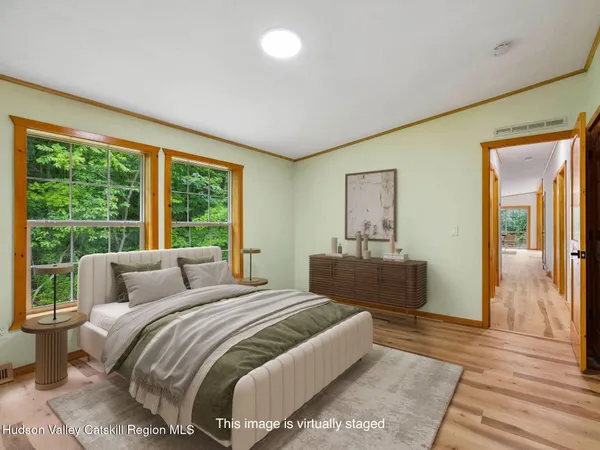 a bedroom with a bed and a large window