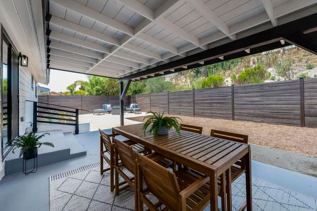 a view of backyard with sitting area