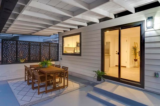 a room with furniture and large windows