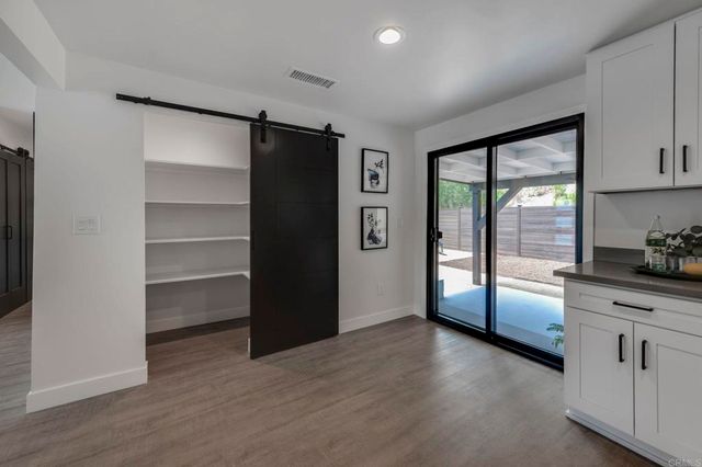 a view of an empty room with a kitchen