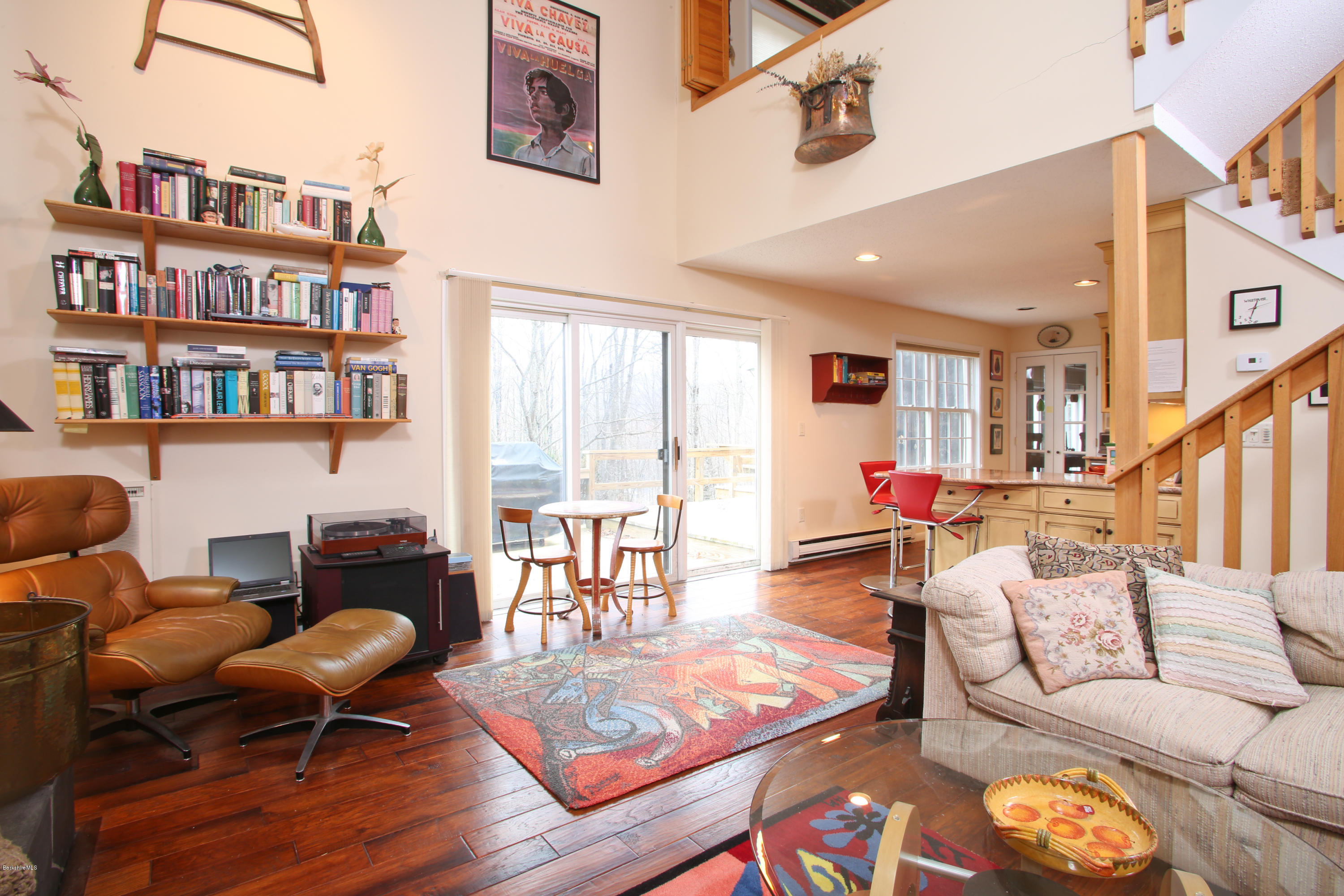 1041-104 Beaver Pond Road, Unit A Hancock, MA 01237 - Photo 1 of 13 a living room with furniture a rug and a book shelf