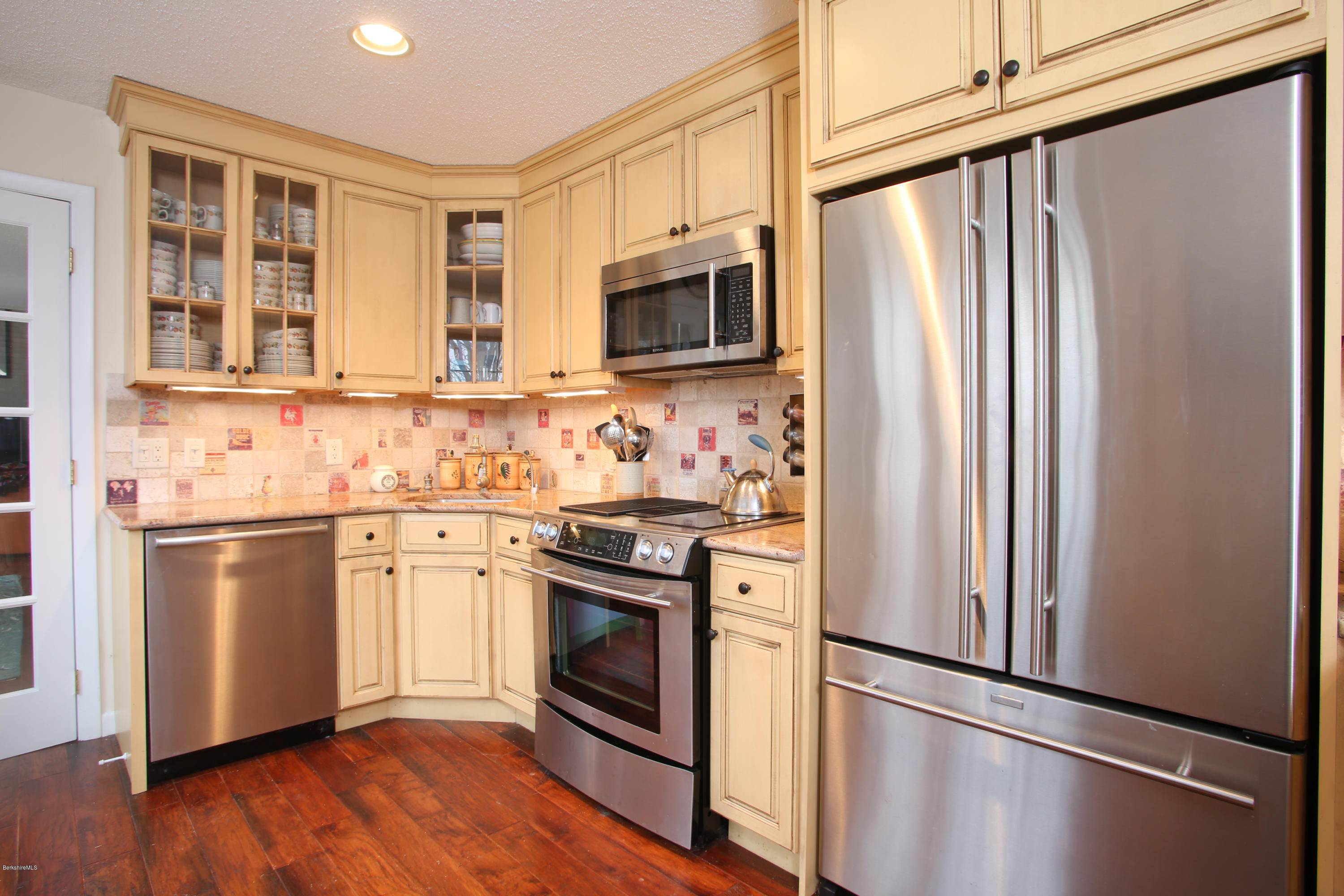 1041-104 Beaver Pond Road, Unit A Hancock, MA 01237 - Photo 9 of 13 a kitchen with stainless steel appliances a refrigerator stove and microwave