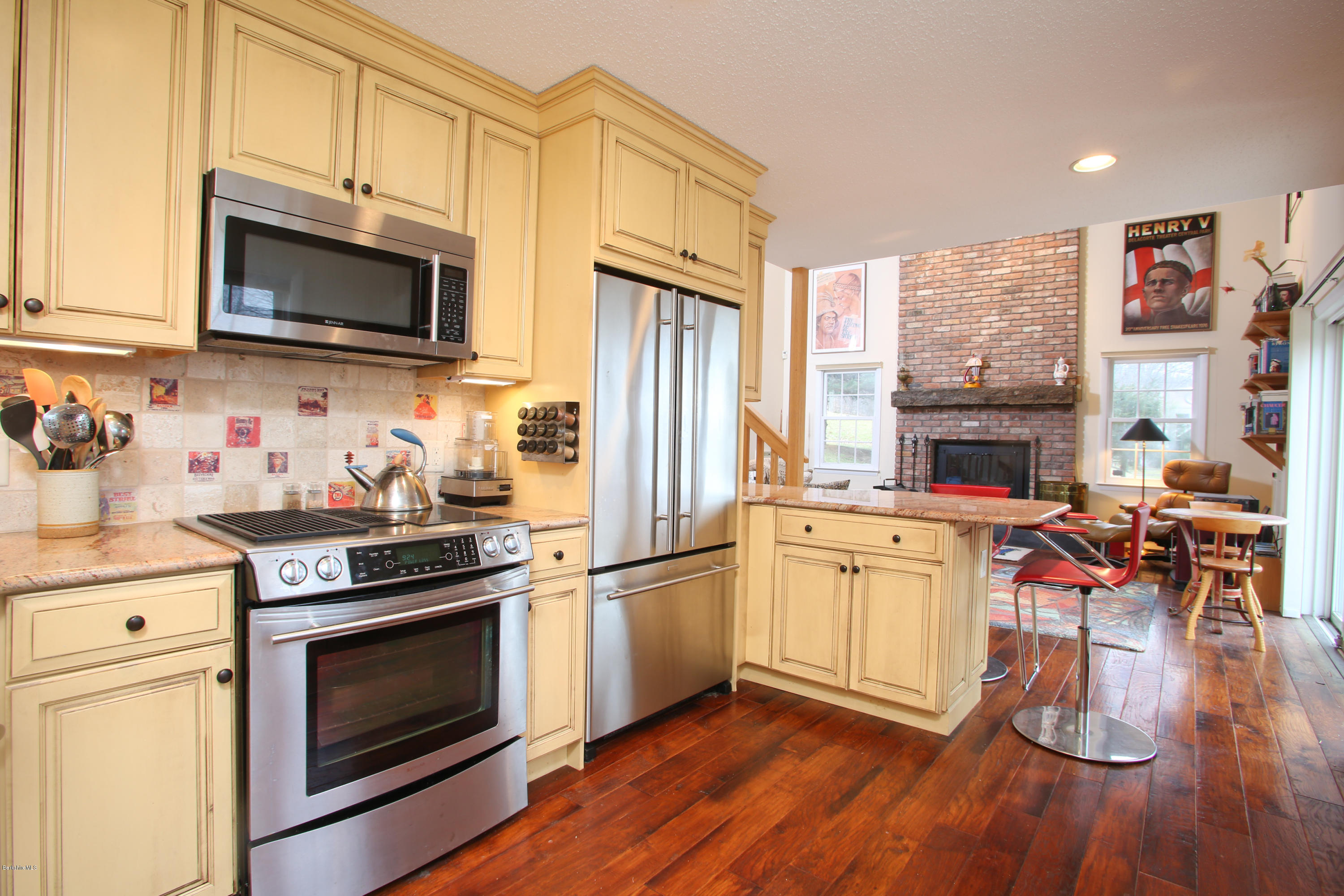 1041-104 Beaver Pond Road, Unit A Hancock, MA 01237 - Photo 10 of 13 a kitchen with stainless steel appliances a stove a sink dishwasher and a microwave oven with wooden floor