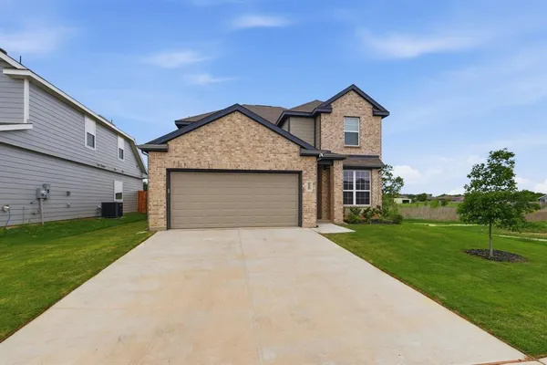 a front view of a house with yard
