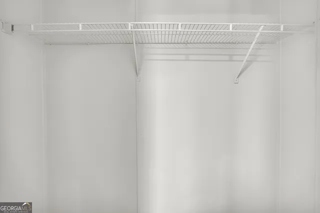 a view of a livingroom with a ceiling fan and window