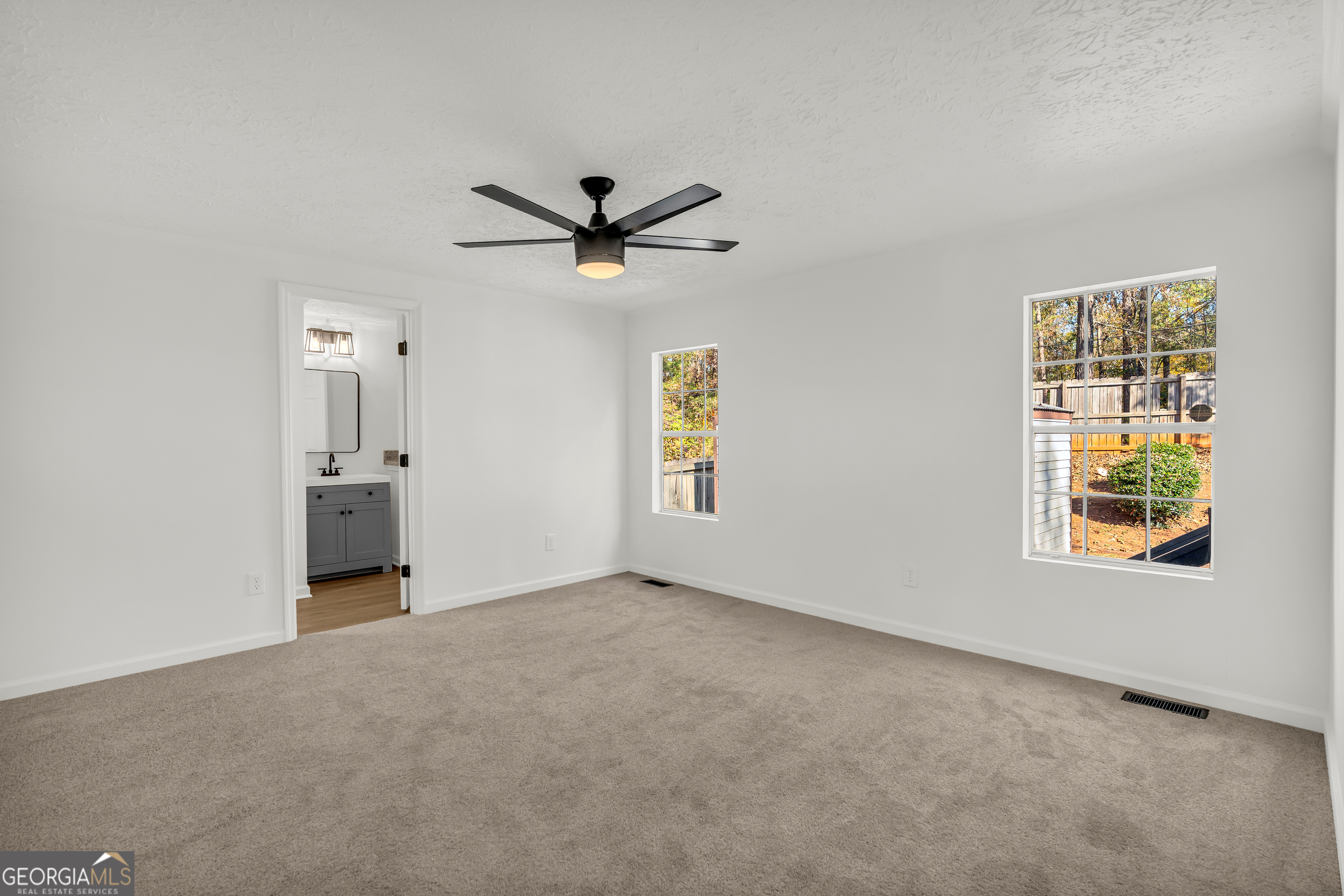 395 Barnetts Bridge Road Jackson, GA 30233 - Photo 16 of 82 an empty room with a window and a ceiling fan