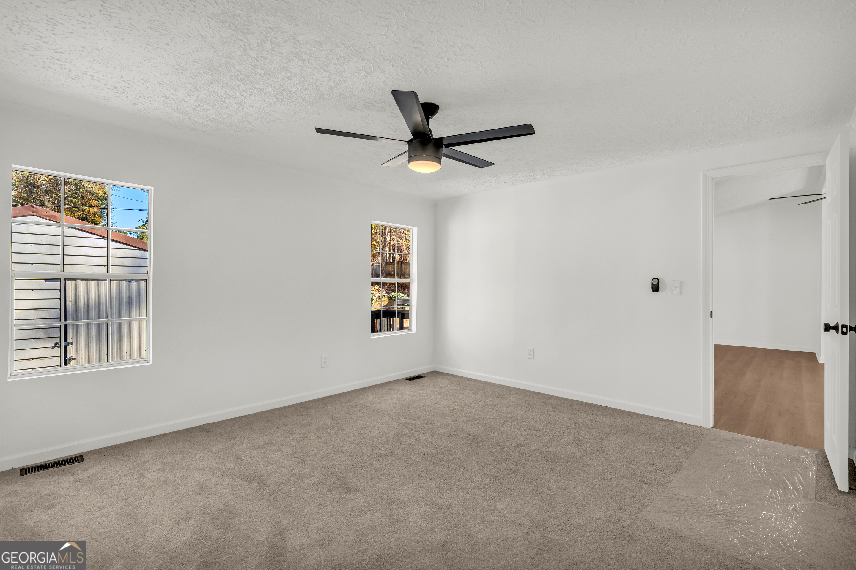 395 Barnetts Bridge Road Jackson, GA 30233 - Photo 17 of 82 a view of a livingroom with a ceiling fan and window