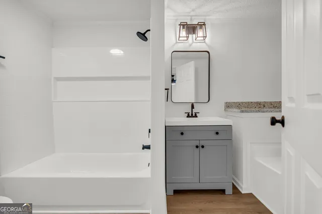 a kitchen with a sink a window and cabinets
