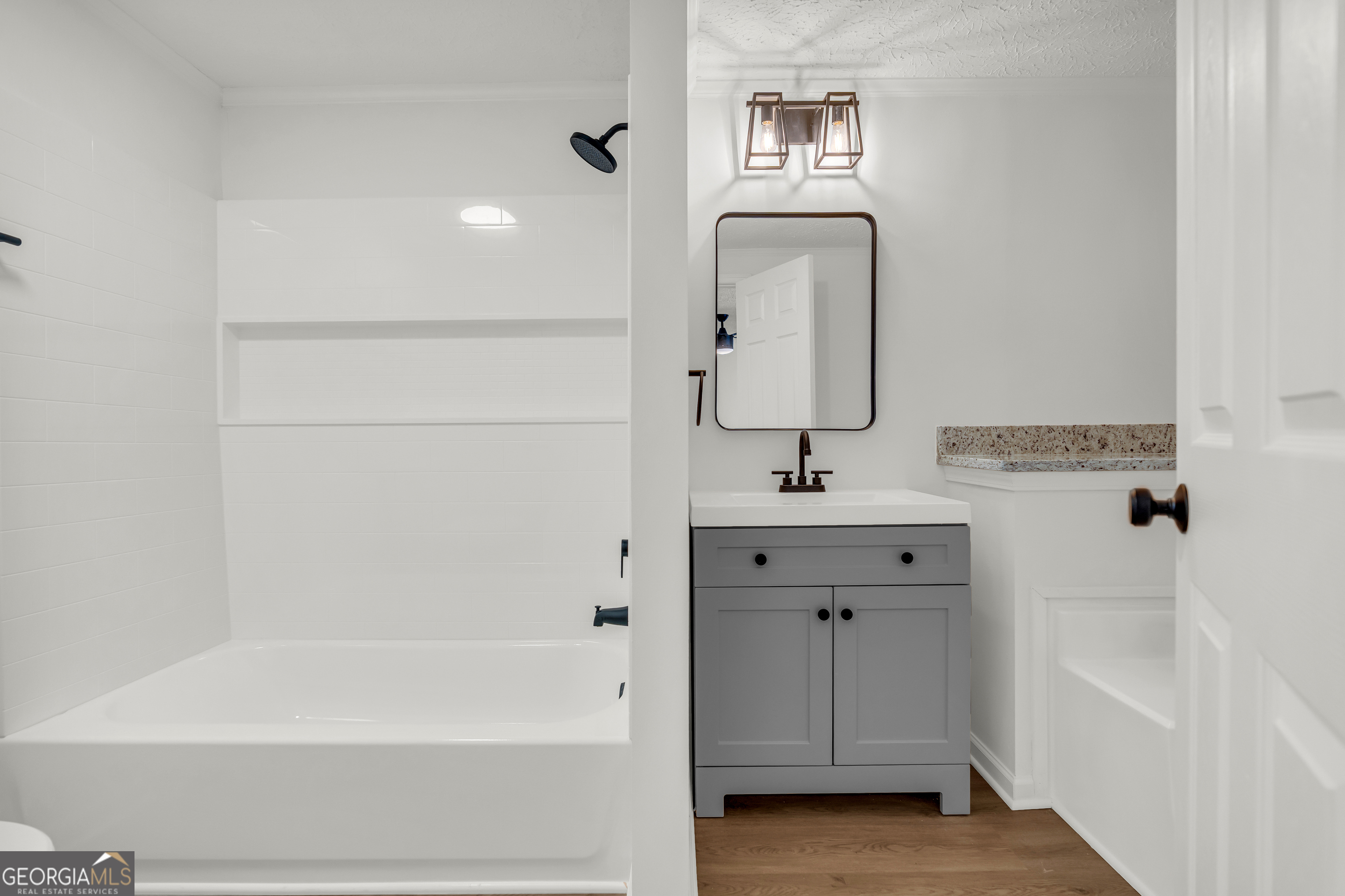 395 Barnetts Bridge Road Jackson, GA 30233 - Photo 20 of 82 a bathroom with a sink a tub and a mirror