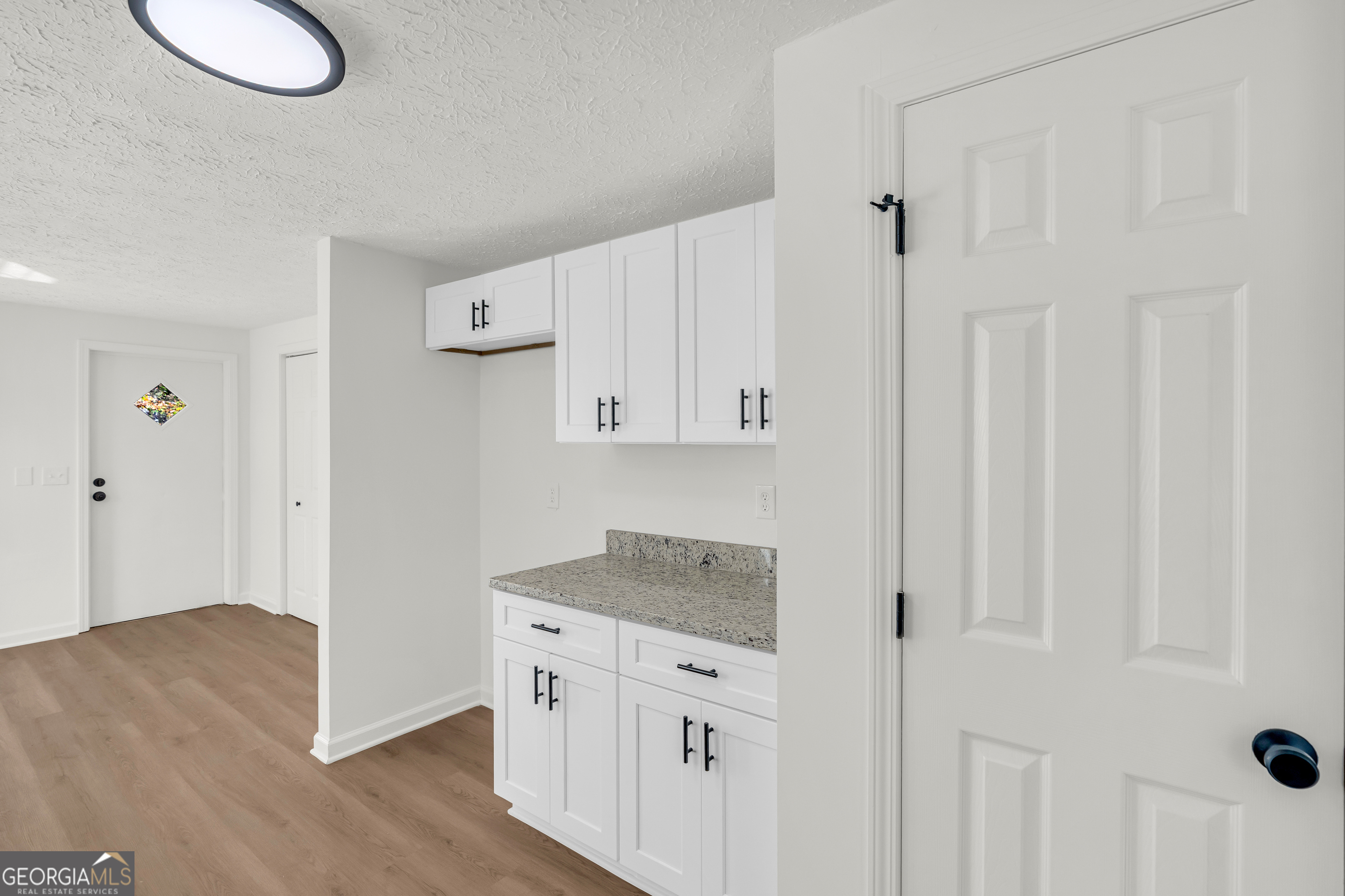 395 Barnetts Bridge Road Jackson, GA 30233 - Photo 27 of 82 a kitchen with granite countertop white cabinets and refrigerator