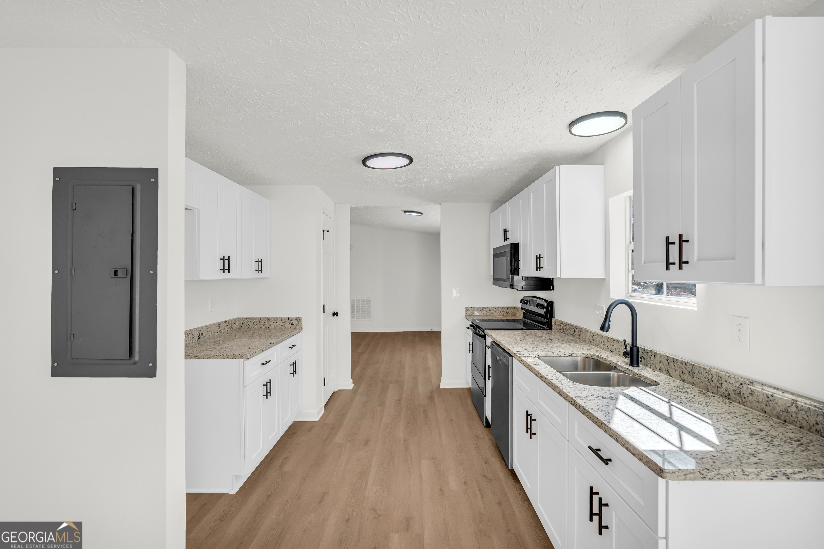 395 Barnetts Bridge Road Jackson, GA 30233 - Photo 31 of 82 a kitchen with granite countertop a sink stove and refrigerator
