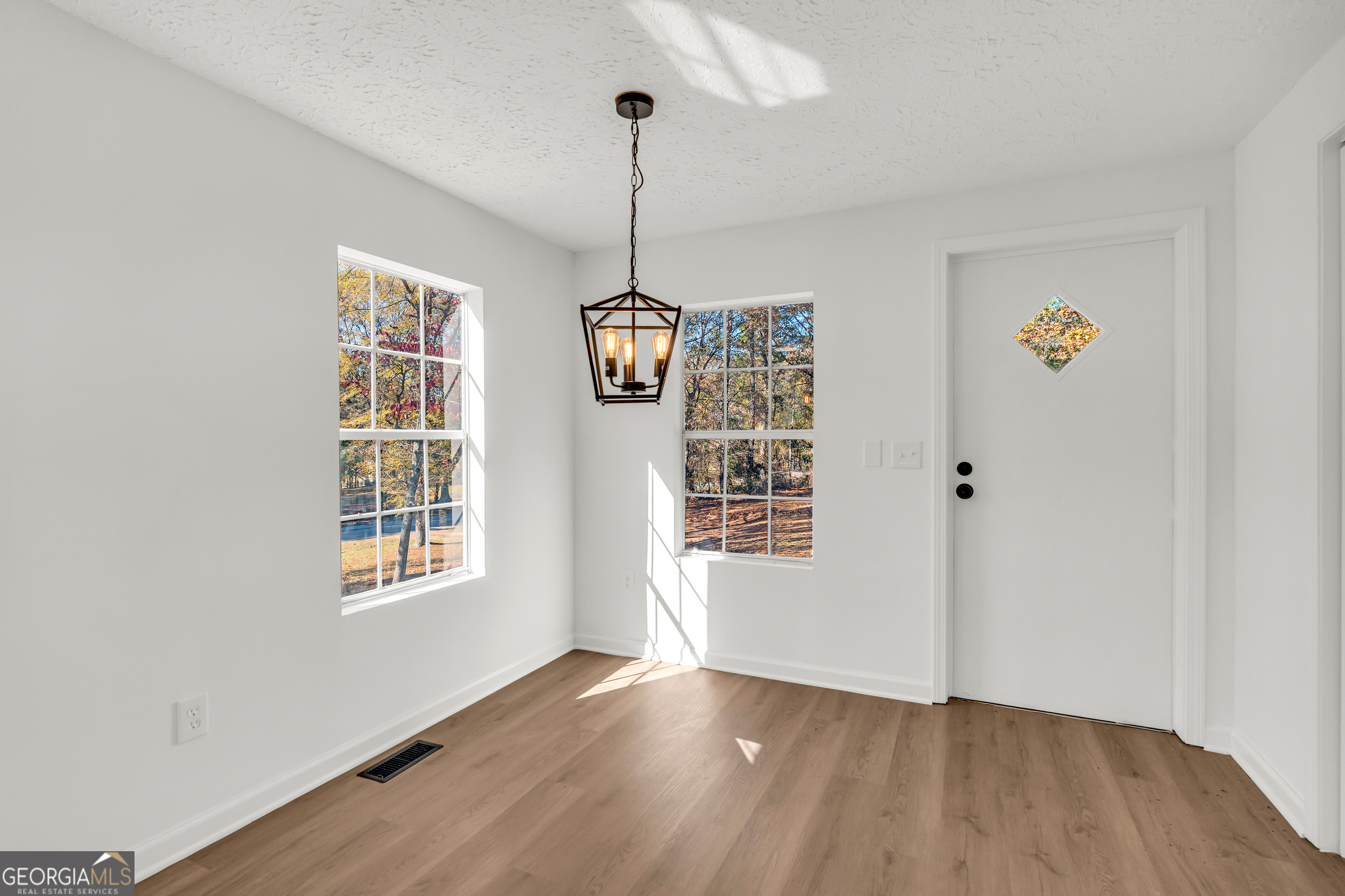 395 Barnetts Bridge Road Jackson, GA 30233 - Photo 32 of 82 a view of an empty room with a window and wooden floor