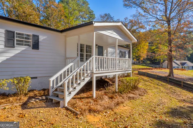 a backyard of a house with table and chairs