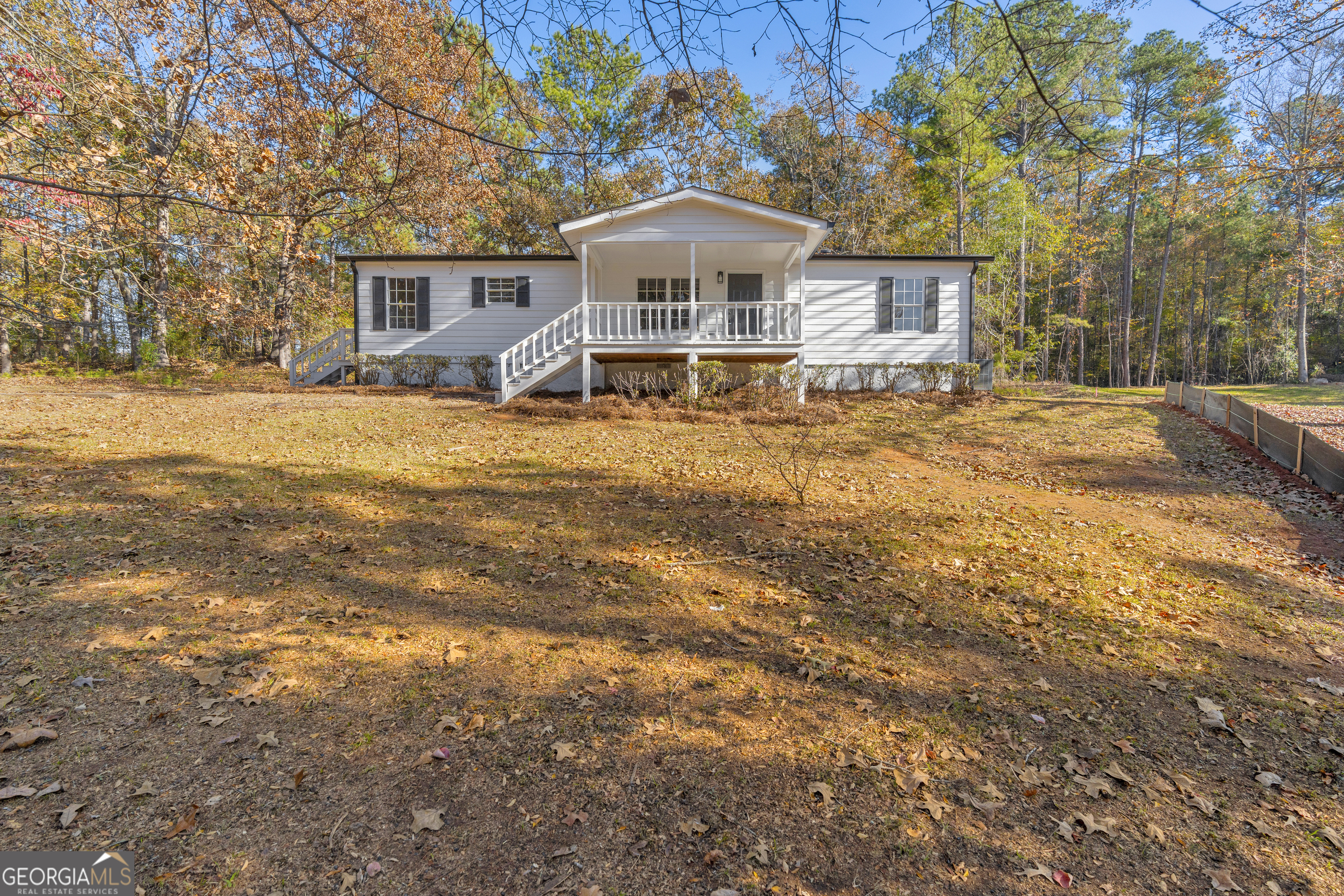 395 Barnetts Bridge Road Jackson, GA 30233 - Photo 44 of 82 a front view of a house with a yard and trees