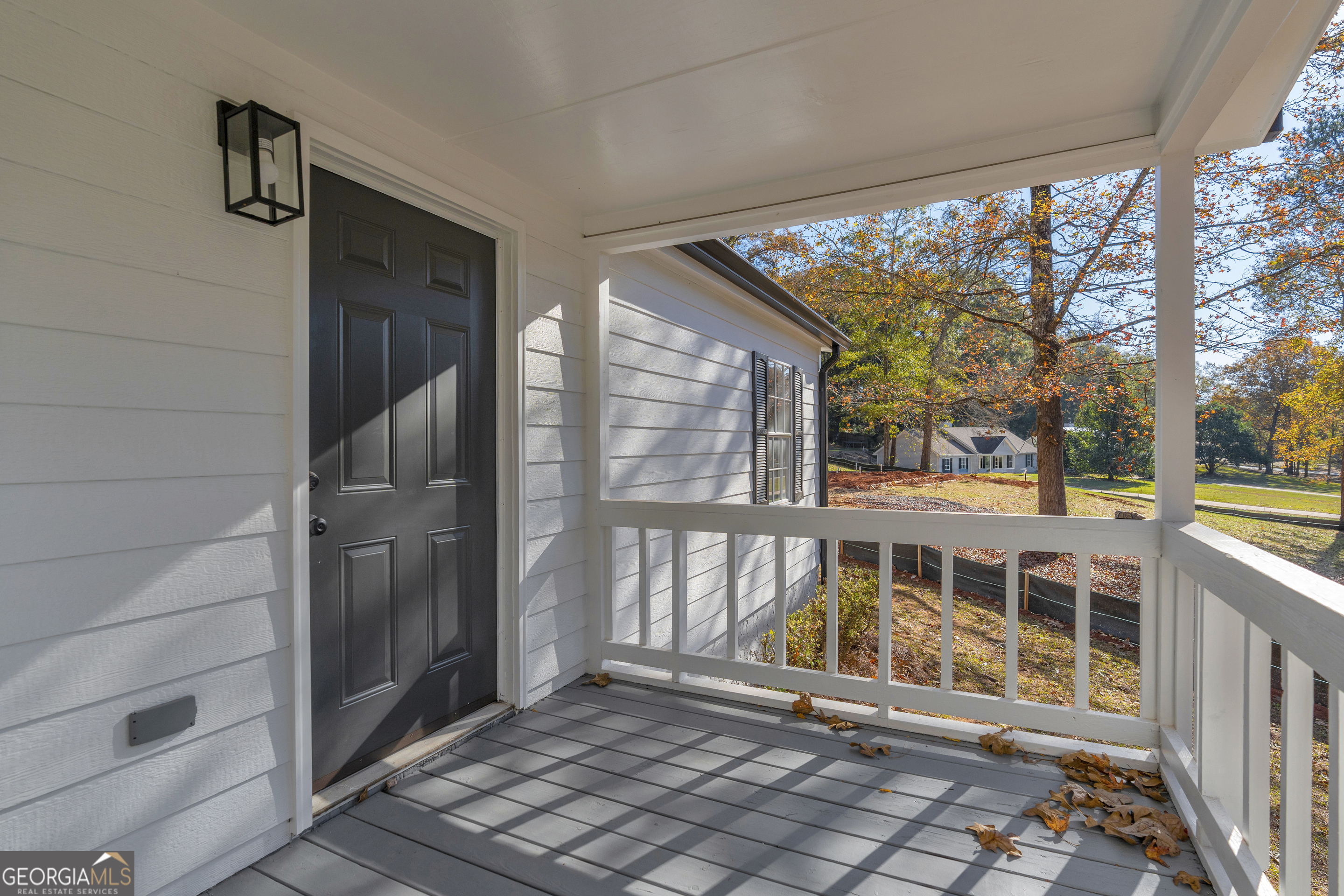 395 Barnetts Bridge Road Jackson, GA 30233 - Photo 47 of 82 a view of a porch with a table and chairs