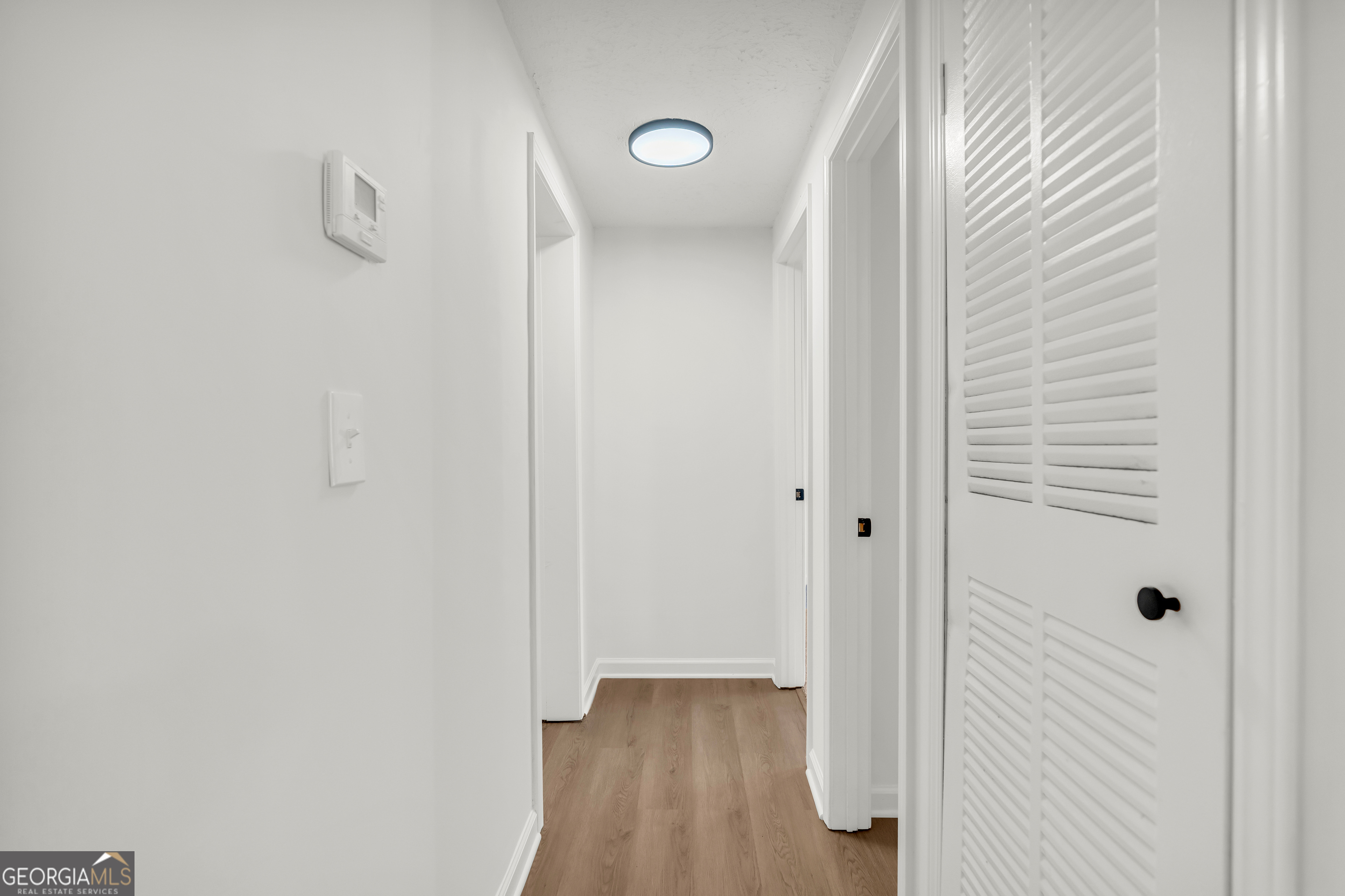 395 Barnetts Bridge Road Jackson, GA 30233 - Photo 8 of 82 a view of a hallway with wooden floor