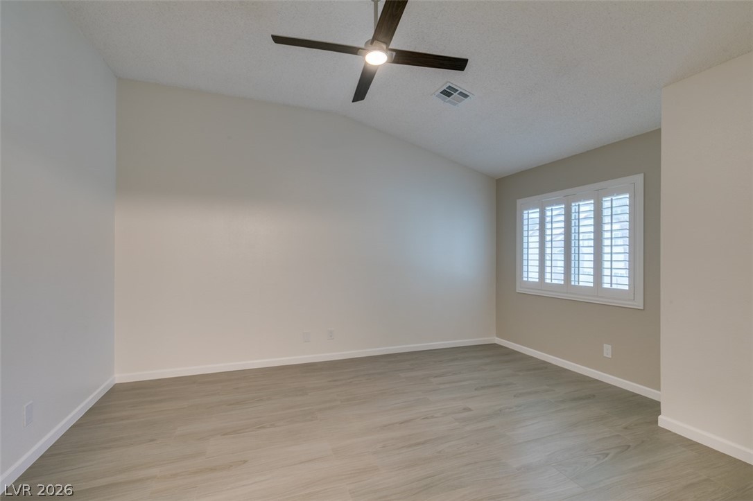540 Sutters Mill Road Henderson, NV 89014 - Photo 35 of 46 This bright bedroom features a vaulted ceiling, durable flooring, and elegant window shutters.