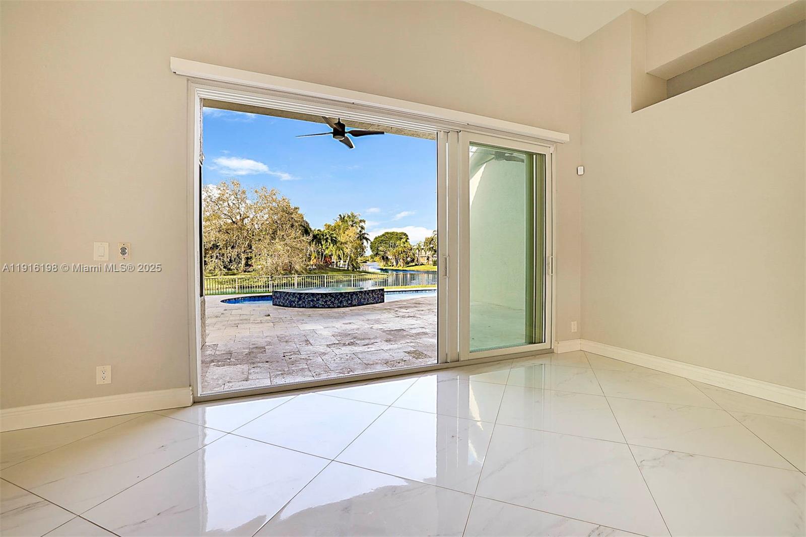 10133 Northwest 48th Drive Coral Springs, FL 33076 - Photo 11 of 49 a view of a glass door with a yard
