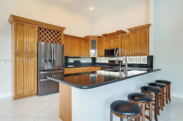a kitchen with stainless steel appliances granite countertop a sink and cabinets