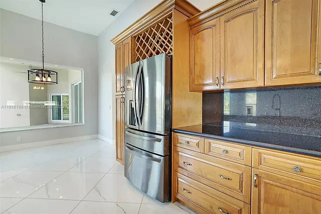 a view of a kitchen with a sink and chandelier