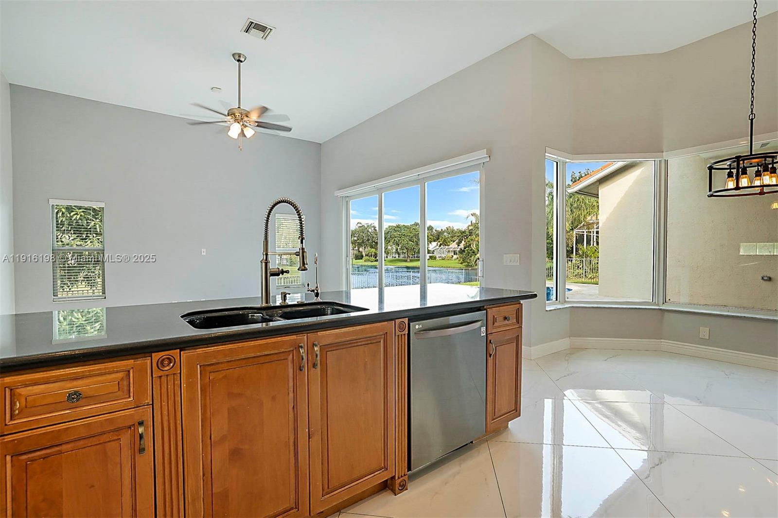 10133 Northwest 48th Drive Coral Springs, FL 33076 - Photo 18 of 49 a view of a kitchen with a sink and chandelier