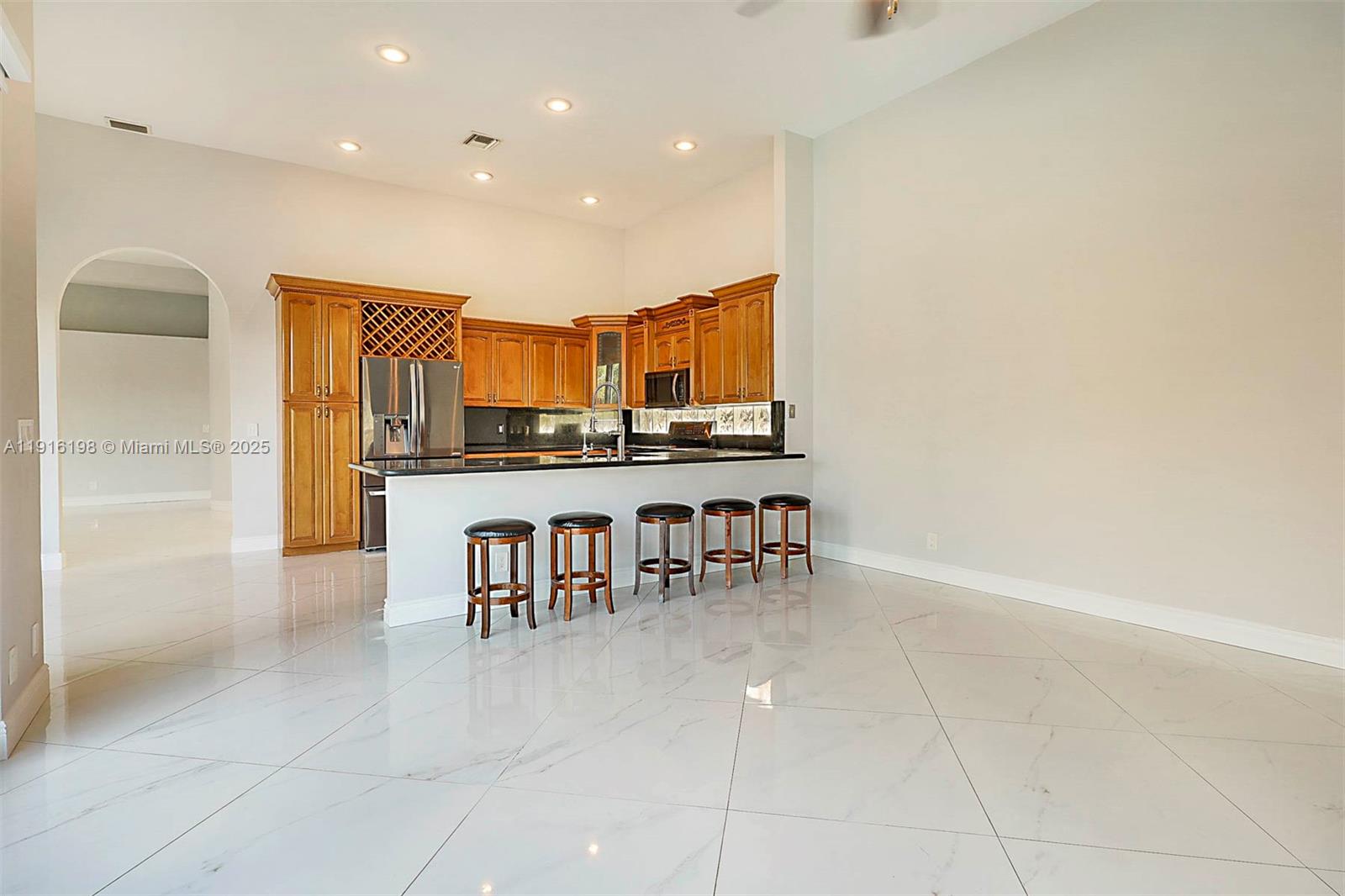10133 Northwest 48th Drive Coral Springs, FL 33076 - Photo 19 of 49 a dining hall with stainless steel appliances a dining table and chairs
