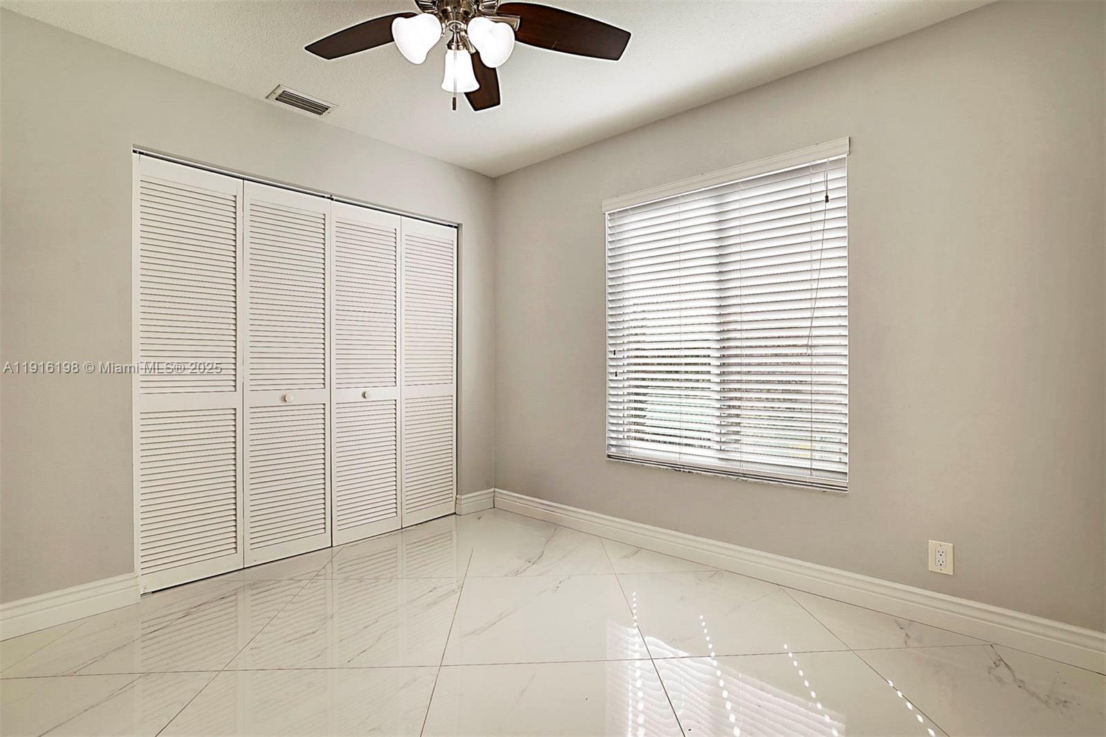 10133 Northwest 48th Drive Coral Springs, FL 33076 - Photo 29 of 49 a view of an empty room with a window