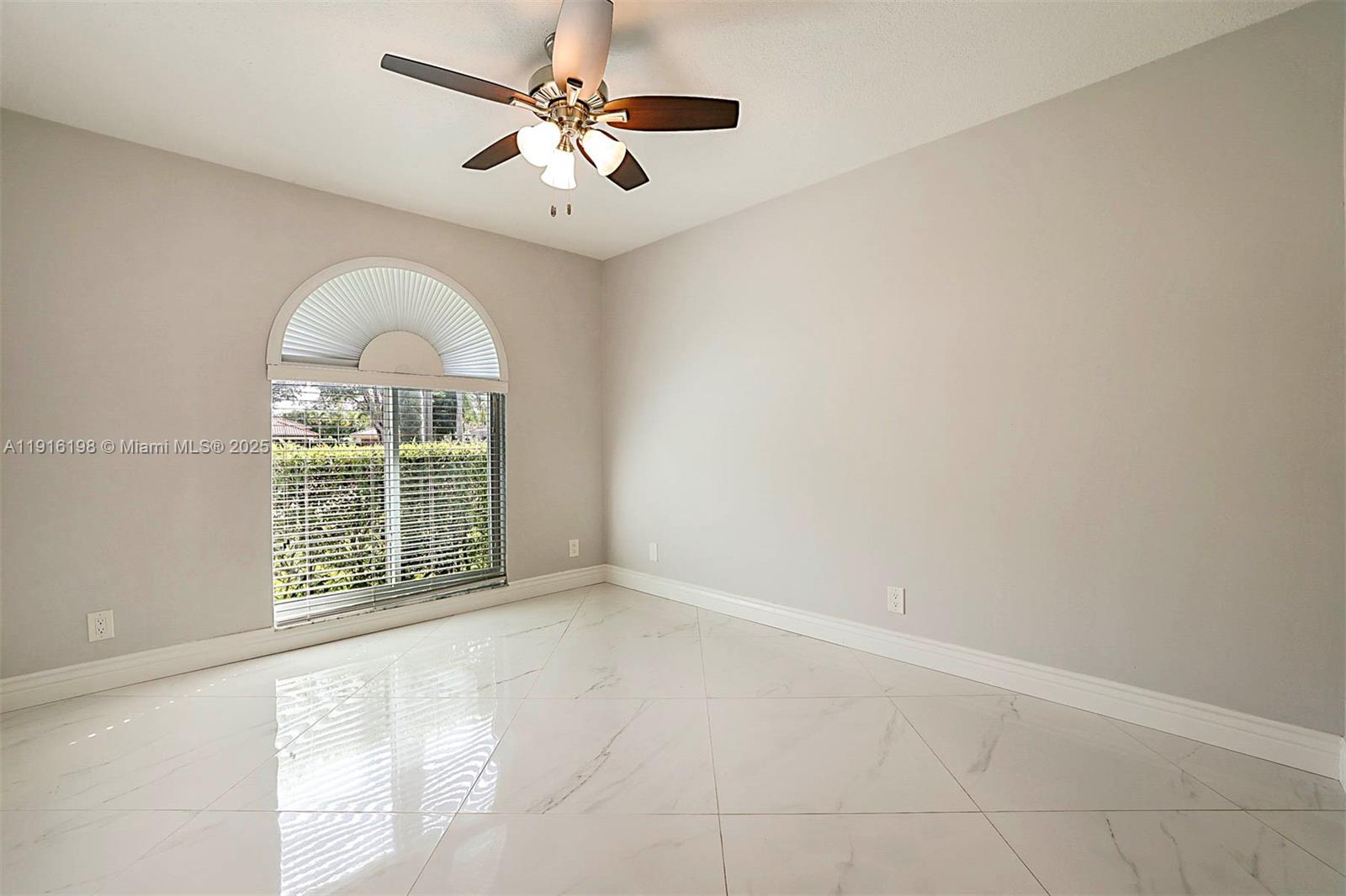 10133 Northwest 48th Drive Coral Springs, FL 33076 - Photo 31 of 49 an empty room with windows and ceiling fan