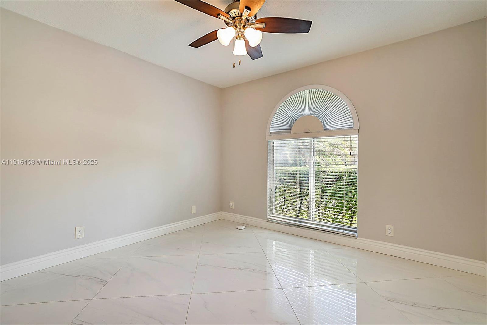10133 Northwest 48th Drive Coral Springs, FL 33076 - Photo 33 of 49 an empty room with chandelier fan and windows
