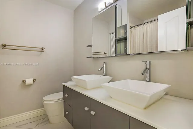 a view of a hallway with chandelier and glass door