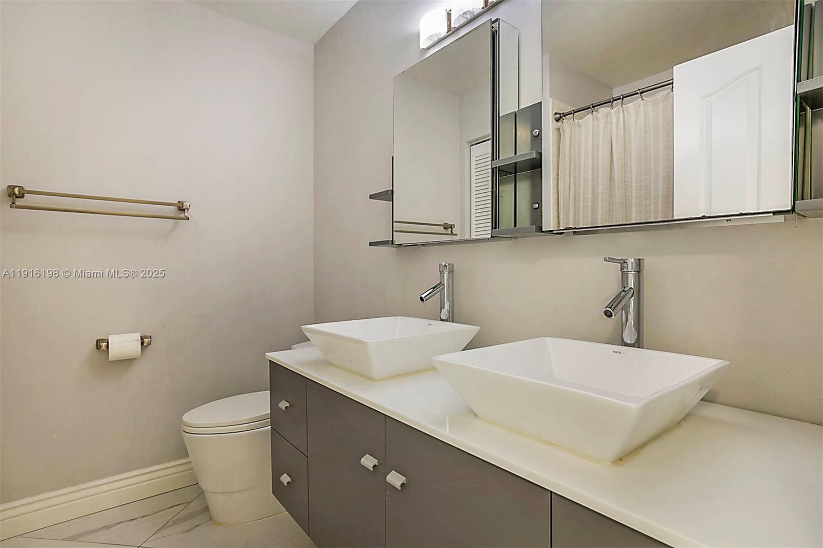 10133 Northwest 48th Drive Coral Springs, FL 33076 - Photo 34 of 49 a bathroom with a sink and a mirror