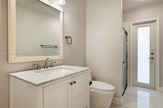 a view of a big room with windows and chandelier
