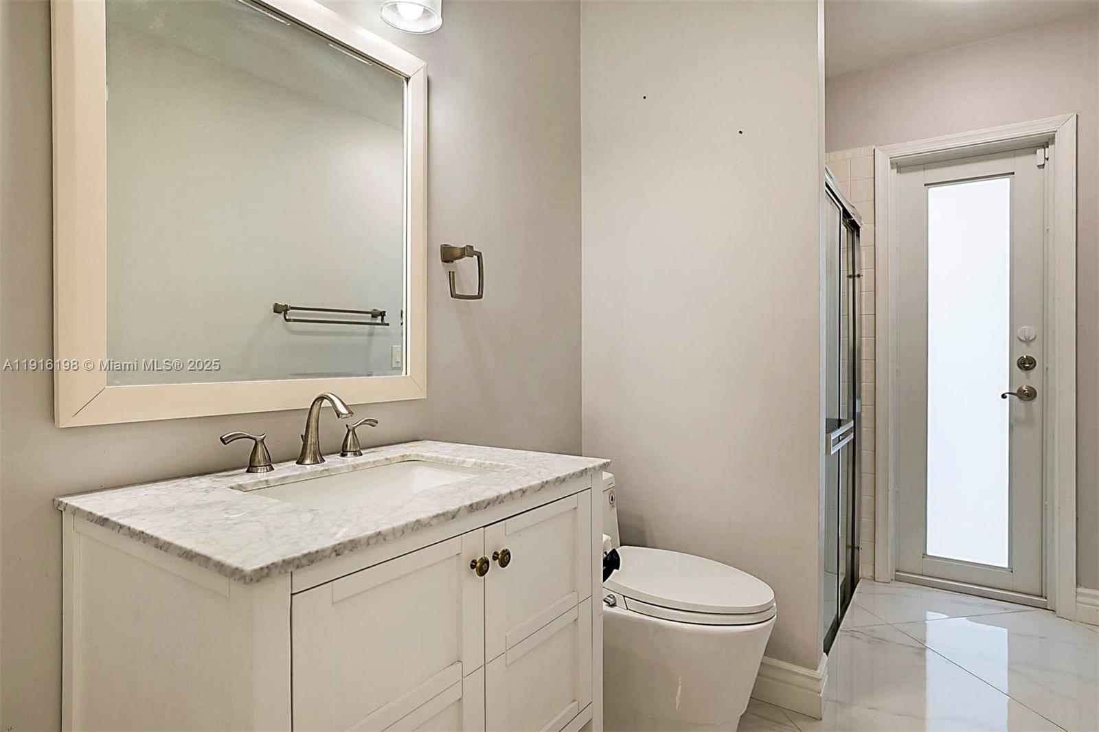 10133 Northwest 48th Drive Coral Springs, FL 33076 - Photo 36 of 49 a bathroom with a sink toilet and vanity